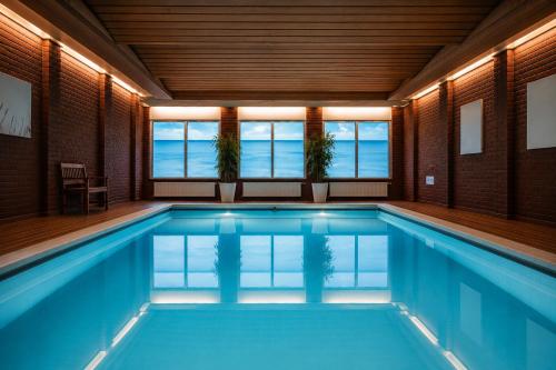 a swimming pool with a view of the ocean at Hotel Hof van Gelre by Flow in Lochem