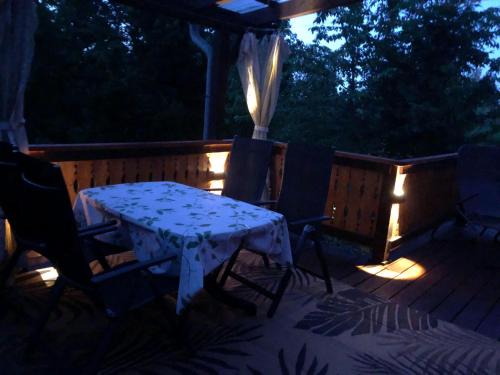 a table and chairs on a patio at night at Ferienhaeuser-Am-Eichenberg-Haus-1 in Blankenburg