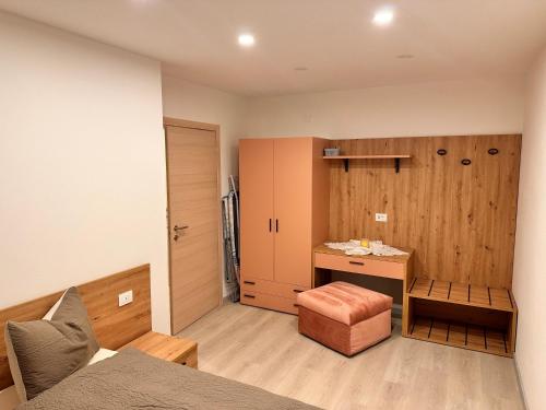 a bedroom with a bed and a desk in a room at Casa D'Ambros - Cadore in Santo Stefano di Cadore