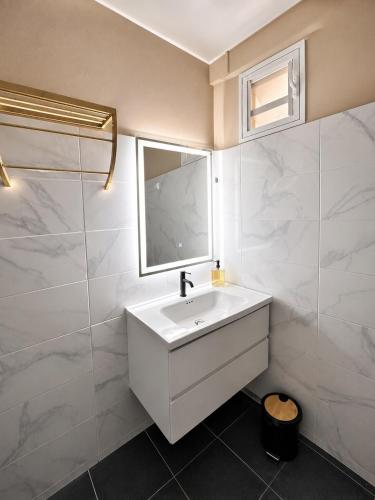 a bathroom with a white sink and a mirror at Villa R-A in Kourou
