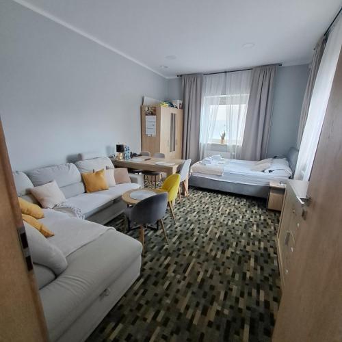 a living room with a couch and a bed at Welle DOLCE VITA in Grzybowo