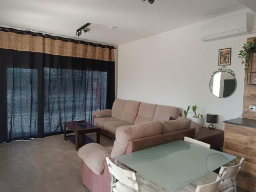 a living room with a couch and a table at Suite Poblamar in Pobla de Montornés