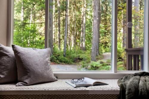 a book and glasses sitting on a window sill at Mt Baker Den, Sleeps 4 in Glacier