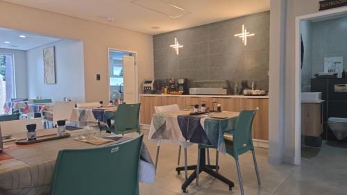 a restaurant with tables and chairs and a counter at 78onJean in Centurion