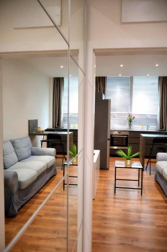 a living room with a couch and a table at Apartman Deluxe Astrova B in Bratislava