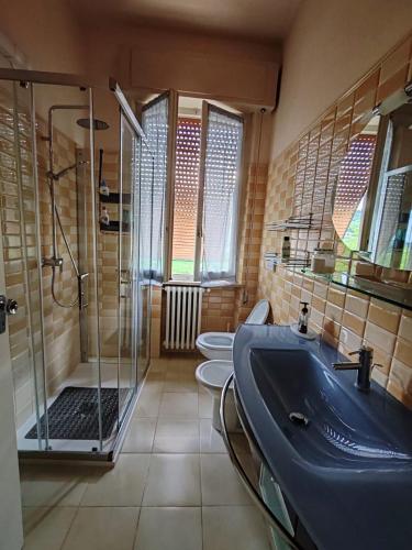 a bathroom with two toilets and a sink and a shower at Casa di nonna in Bevagna