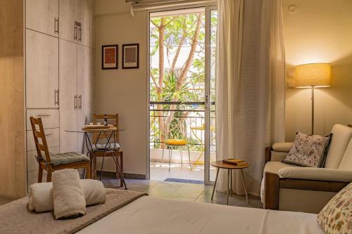 a bedroom with a bed and a living room at Studio74 in Patra
