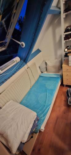 a small room with a bed in a boat at Homestay Maashees in Maashees