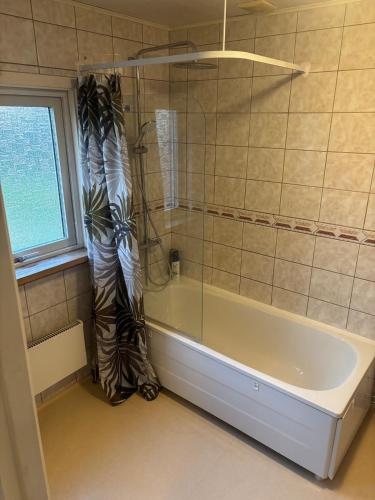 a bathroom with a shower and a bath tub at Villa in Kvidinge