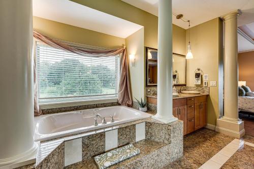 a large bathroom with a tub and a window at Private Getaway! Massive Springfield Area Home in Rogersville