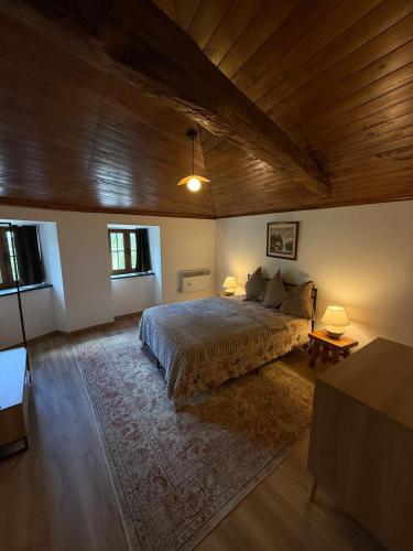 a bedroom with a bed and a wooden ceiling at Casa D Matilde in Góis