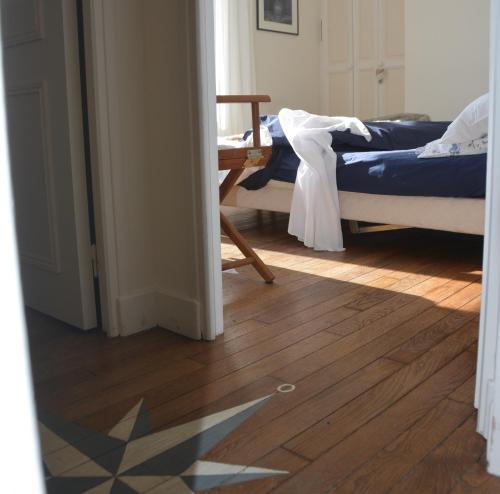 a bedroom with two beds and a wooden floor at Gîte La Bertichère in Saint-Jean-le-Thomas