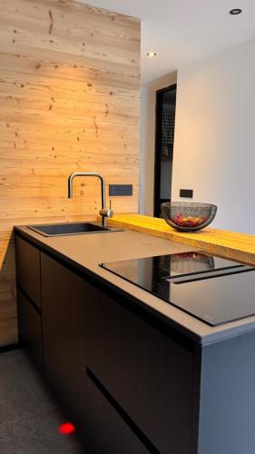 a kitchen with a sink and a counter at Coriva Homes - Cogolo in Cogolo