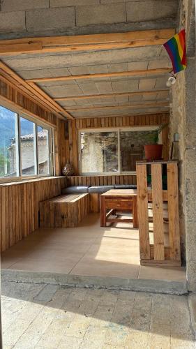 a wooden sauna with a wooden table and a bench at maisonnette in Menglon