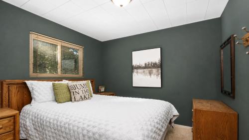 a bedroom with a bed with a white bedspread at Smoke Tree Hollow AC Pine Air in Shaver Lake
