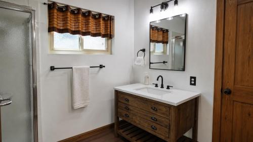 a bathroom with a sink and a mirror at Smoke Tree Hollow AC Pine Air in Shaver Lake