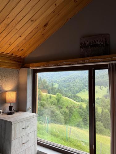 a room with a large window with a view at Mitarbi Silence - cozy holiday cottages in mountains 
