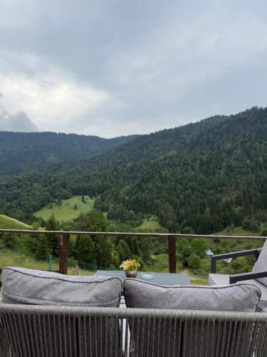 a balcony with a view of a mountain at Mitarbi Silence - cozy holiday cottages in mountains 