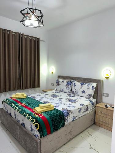 a bedroom with a bed with a blanket on it at Bujtina4A Rrenc in Renc
