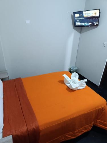 a room with a bed with a towel on it at HOTEL BOUTIQUE TerrazaINN in Arequipa