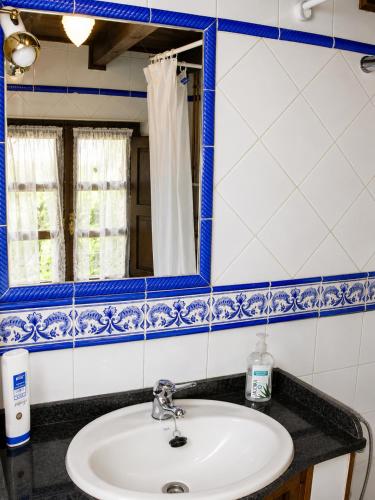 a bathroom with a sink and a mirror at La Casina de Celorio in Celorio