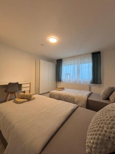 a hotel room with two beds and a couch at AG Apartments Waiblingen in Waldmühle
