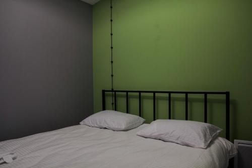 a bedroom with a bed with two pillows on it at Villatun in Stepʼanavan