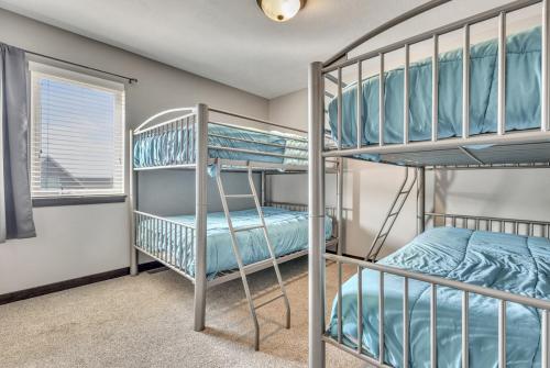 a bunk room with two bunk beds and a window at Bridges Bay Vacation Cabin 279 in Arnolds Park