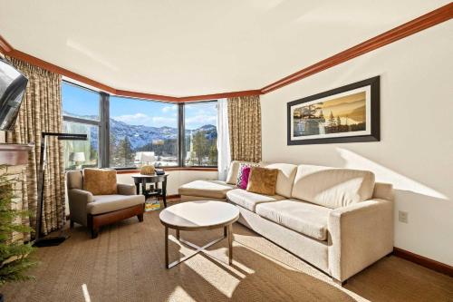 a living room with a couch and a table at Remodeled Second Floor Valley View suite no resort fee in Olympic Valley