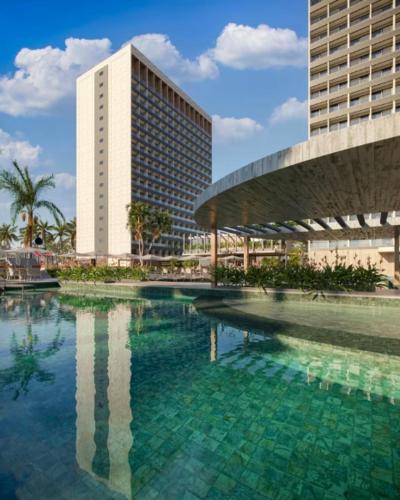 a large pool of water in front of a building at Beach GAV Resort in Salinópolis
