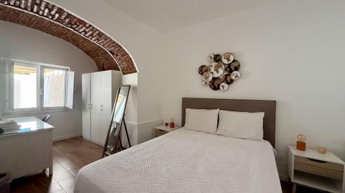 a bedroom with a bed and a chandelier on the wall at Habita SerpaPinto in Estremoz