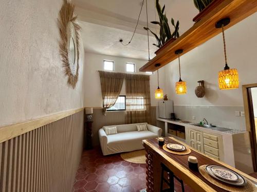 a kitchen and living room with a table and a couch at Casa Lo de Linda in Lo de Marcos