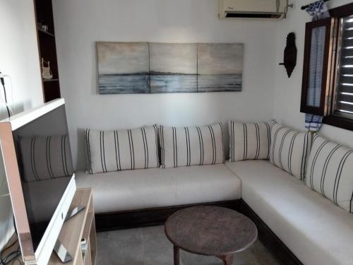 a living room with a white couch and a table at Maison de plage Marsa M'diq 2 chambres et Salon in M'diq