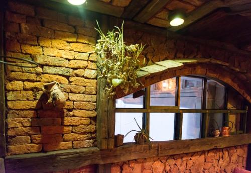 a window in a brick wall with a vase on it at Motel Orhideja in Donji Vakuf