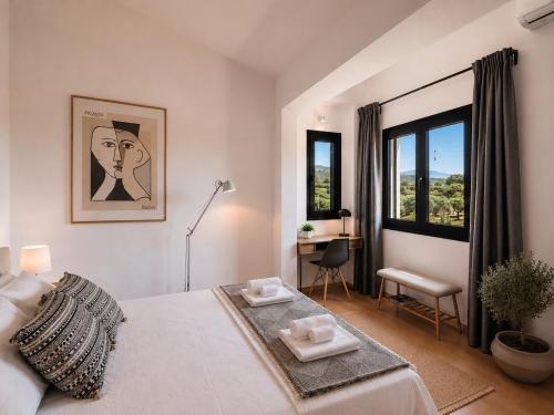 a white bedroom with a bed and a desk and windows at Gregorys Private Luxury Villa with Heated Pool & Gardens in SFakianalíon