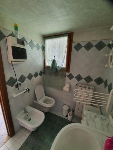 a small bathroom with a sink and a toilet at Deby House in Oggebbio