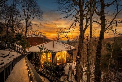 a gazebo covered in snow at sunset at Breathtaking Boutique Treehouse nestled in clouds in Beech Mountain