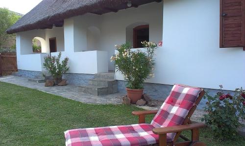 a chair sitting in front of a house at Country house Balaton in Paloznak