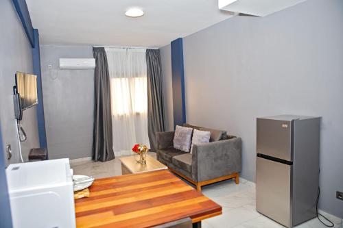 a living room with a couch and a table at Angel's hôtel in Douala