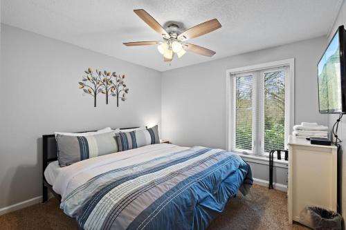 a bedroom with a bed and a ceiling fan at Hiking Trails King Bed View Recently Renovated in Sugar Mountain
