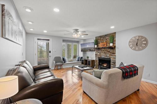 a living room with two couches and a fireplace at Hiking Trails King Bed View Recently Renovated in Sugar Mountain