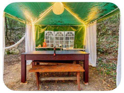 a ping pong table in a green tent at Glamping Boutique in Comillas