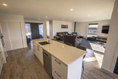 a living room with a kitchen and a living room with a couch at Stay at 2A in Twizel