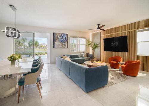 a living room with a blue couch and a table at Villatel Orlando Resort in Orlando