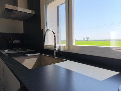 a kitchen counter with a sink and a window at Sweet November in Valencia