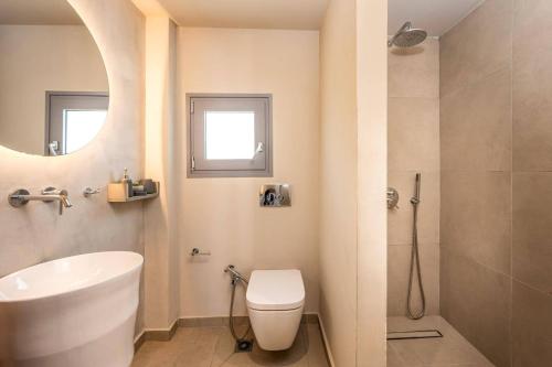 a bathroom with a toilet and a sink and a shower at Villa Romas 2 by Villa Plus in Vasilikos