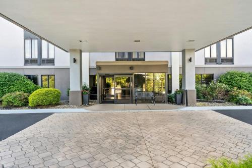 a building with a courtyard with a patio at Allentown Park Hotel by The Red Collection in Fogelsville