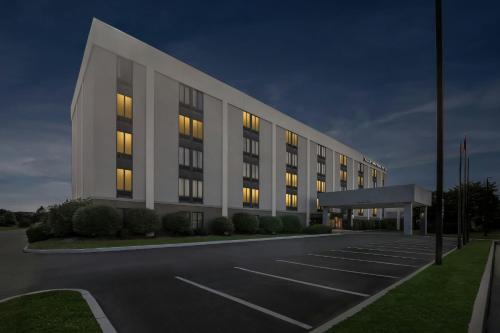 an empty parking lot in front of a building at Allentown Park Hotel by The Red Collection in Fogelsville