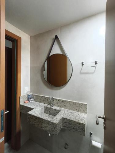 a bathroom with a large sink and a mirror at Duplex Praia de Imbassaí in Mata de Sao Joao
