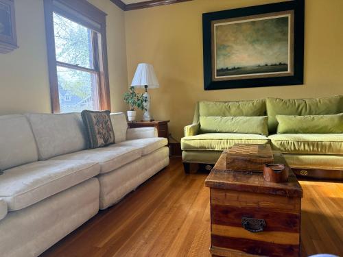 a living room with two couches and a coffee table at This Old Frat House Boutique Guest in Missoula